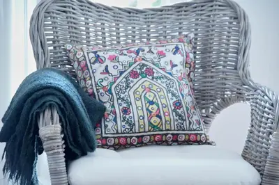a wicker chair with a pillow and a blanket at Carvalhal Old Town in Funchal