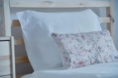 a pillow sitting on top of a bed at Carvalhal Old Town in Funchal