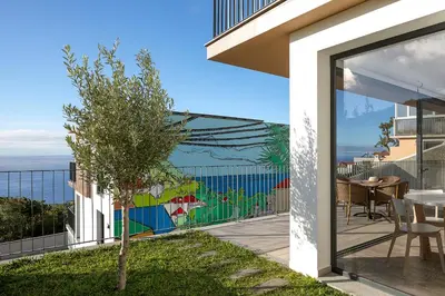 a house with a balcony with a view of the ocean at Marco 4 Seasons- Winter in Arco da Calheta