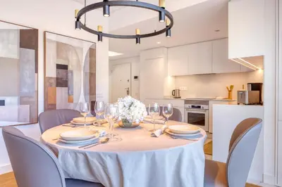 a dining room with a table with chairs and a chandelier at Funchal Acqua Blue 8E, a Home in Madeira in Funchal