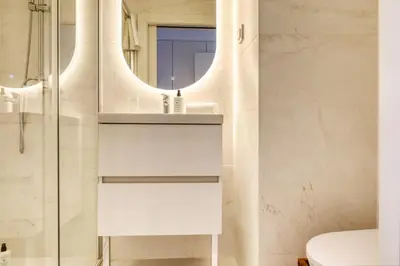 a bathroom with a sink and a mirror at Funchal Acqua Blue 8E, a Home in Madeira in Funchal
