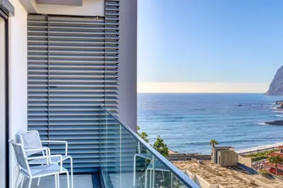a balcony with a view of the ocean at Funchal Acqua Blue 8E, a Home in Madeira in Funchal