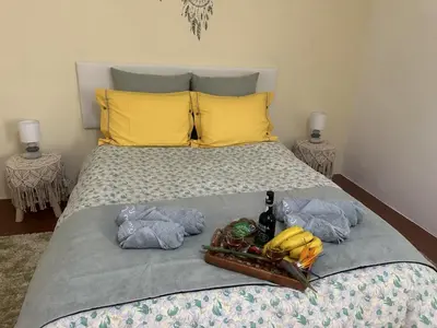 a bed with a tray of bananas on it at Casa Mary Bela's in Ponta do Sol