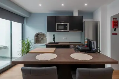 a kitchen with a large wooden table with chairs at Madeira House by Mathias in Funchal