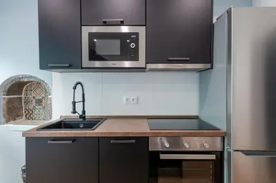 a kitchen with a sink and a microwave at Madeira House by Mathias in Funchal