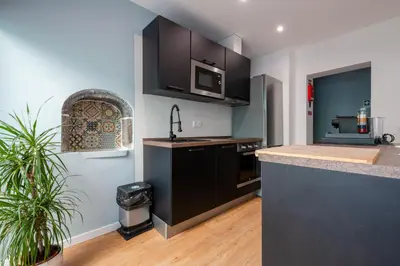 a kitchen with black cabinets and a counter top at Madeira House by Mathias in Funchal