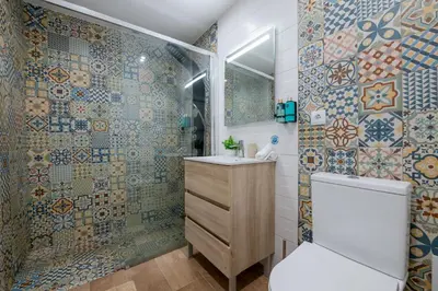 a bathroom with a shower and a toilet and a sink at Madeira House by Mathias in Funchal