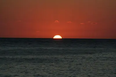 a sunset over the ocean with the sun in the horizon at One Love Maktub in Paul do Mar