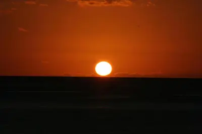 a sunset over the ocean with the sun in the sky at One Love Maktub in Paul do Mar