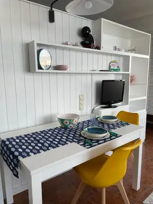 a white table with two chairs and a computer monitor at Ocean View Studio 2 with pool in Funchal