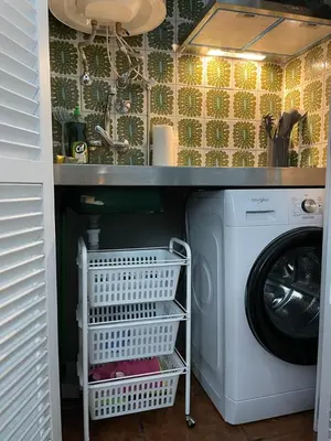 a washing machine under a counter in a kitchen at Ocean View Studio 2 with pool in Funchal