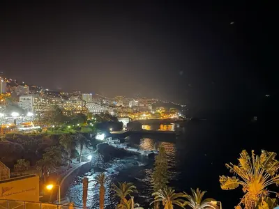 a view of a city at night with a river at Ocean View Studio 2 with pool in Funchal