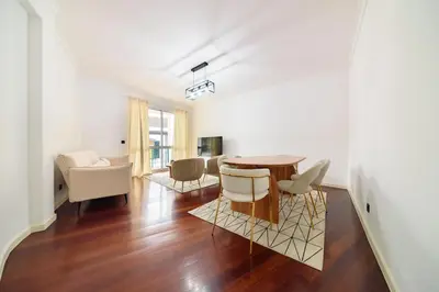 a living room with a table and chairs at Home in Funchal in Funchal
