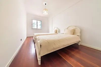 a bedroom with a bed in a white room at Home in Funchal in Funchal