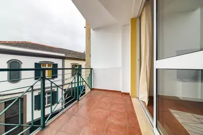 a balcony with a view of a building at Home in Funchal in Funchal