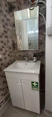 a bathroom with a white sink and a mirror at O CAMPO na CIDADE in Funchal