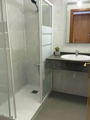 a bathroom with a shower and a sink at BelleMar Vacations in Funchal