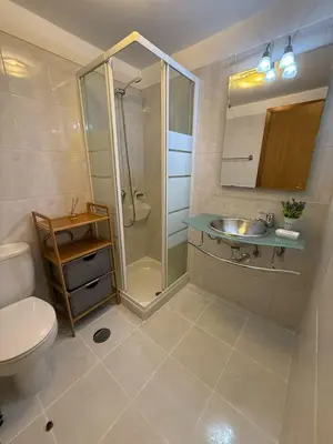 a bathroom with a toilet and a sink and a shower at BelleMar Vacations in Funchal
