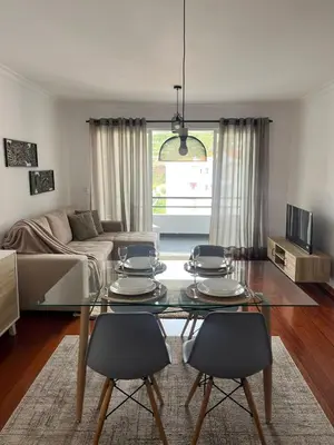a living room with a glass table and chairs at BelleMar Vacations in Funchal