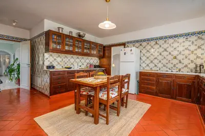 a kitchen with a wooden table and a refrigerator at Spacious villa with sea view, tennis & golf garden #1963 in Alagoas