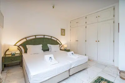 a bedroom with a large bed with two towels on it at Spacious villa with sea view, tennis & golf garden #1963 in Alagoas