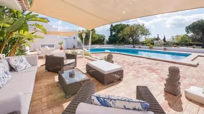an outdoor patio with a swimming pool and chairs and a pool at Spacious villa with sea view, tennis & golf garden #1963 in Alagoas