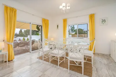 a dining room with a glass table and chairs at Spacious villa with sea view, tennis & golf garden #1963 in Alagoas