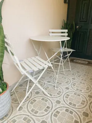 two white chairs and a table and a table and chairs at Dani House - Porto Moniz Escape in Porto Moniz