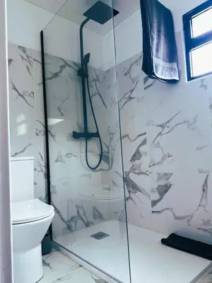 a bathroom with a shower and a toilet at Dani House - Porto Moniz Escape in Porto Moniz