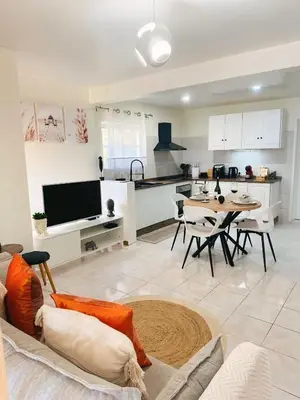 a large living room with a table and a kitchen at Dani House - Porto Moniz Escape in Porto Moniz