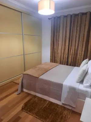 a bedroom with a large bed and a window at Rose Sun House in Ponta do Sol