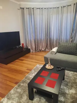 a living room with a couch and a tv at Rose Sun House in Ponta do Sol