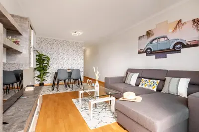 a living room with a couch and a table at Sunflower Living by Homie in Caniço