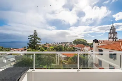 a balcony with a view of a city at Sunflower Living by Homie in Caniço