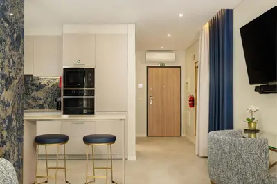 a kitchen with two stools and a counter in a room at Safira Suites 101 in Funchal