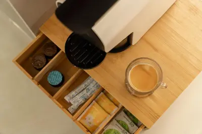 a cup of coffee sitting on a table with a coffee pot at Safira Suites 201 in Funchal