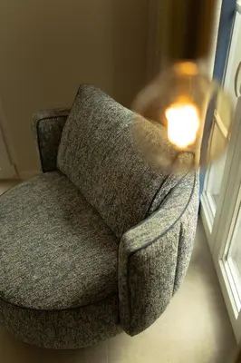 a gray chair with a candle sitting next to a window at Safira Suites 202 in Funchal