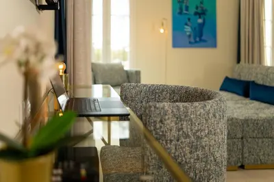 a living room with a laptop on a glass table at Safira Suites 301 in Funchal