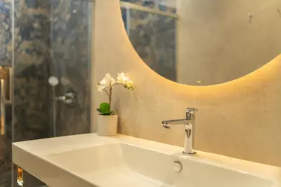a bathroom with a sink and a mirror at Safira Suites 301 in Funchal
