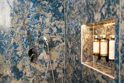 a bathroom with a glass shower stall with bottles at Safira Suites 302 in Funchal