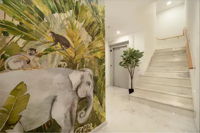 a painting of an elephant in a hallway with stairs at Safira Suites 302 in Funchal