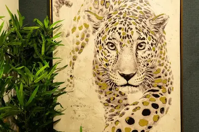 a painting of a jaguar next to a plant at Safira Suites 302 in Funchal