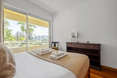 a bedroom with a bed and a large window at Lux Garden View by Homie in Funchal