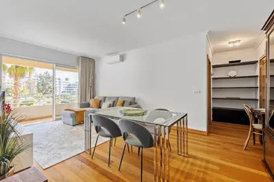 a living room with a glass table and chairs at Lux Garden View by Homie in Funchal