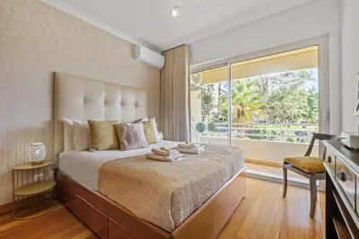 a bedroom with a large bed with a large window at Lux Garden View by Homie in Funchal