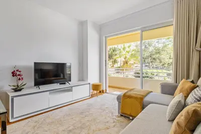 a living room with a television and a couch at Lux Garden View by Homie in Funchal