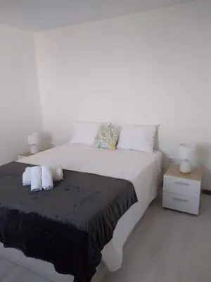 a bedroom with a bed with two pillows on it at Casa Ponte in Ponta do Sol