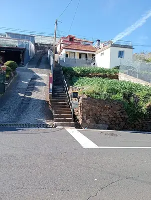 a set of stairs leading down to a house at Casa Ponte in Ponta do Sol