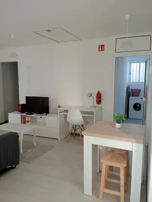 a white living room with a table and a desk at Casa Ponte in Ponta do Sol