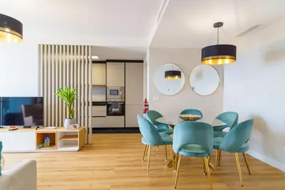a dining room with a table and blue chairs at GuestReady - The perfect place to relax in Funchal in Funchal